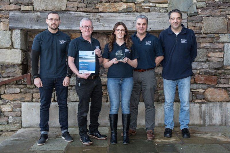 Group photo of Scottish Water's Sustainable Land Management Team holding winners trophy of the Shetland Environmental Award for Peatland ACTION funded restoration work at Sandy Loch (2017).