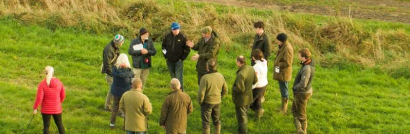 Farmer group standing in field