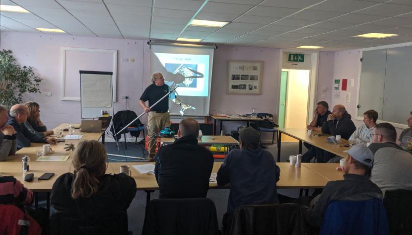 A man presenting a power point presentation to a group of people.