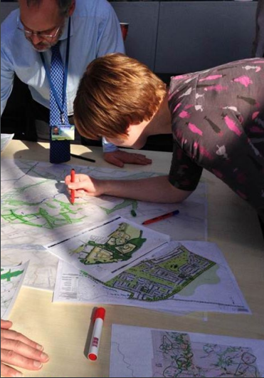 two people planning using maps to contribute to place-based working