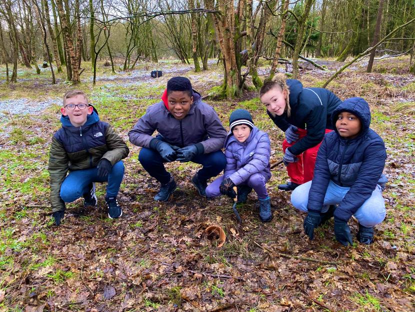 Five primary school boys in a woodland
