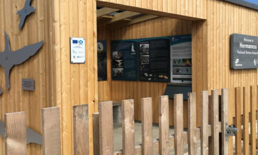 Wooden visitor centre with information panels inside