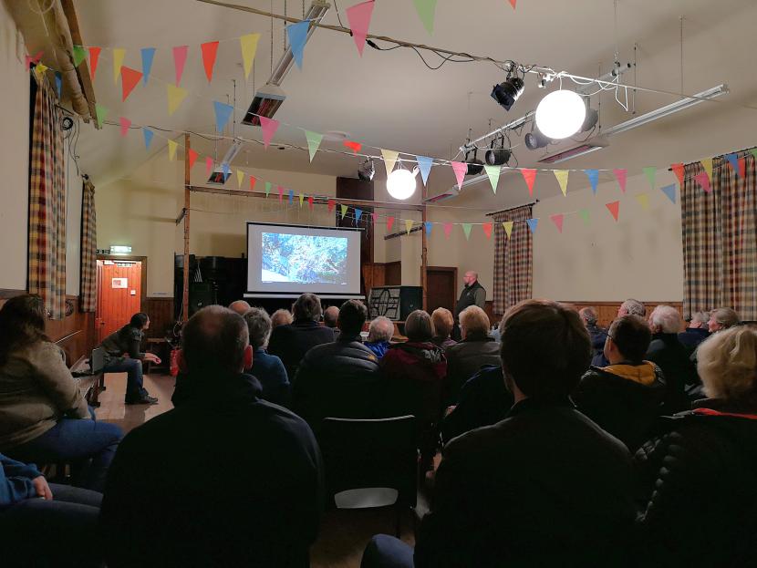 Project staff and partners giving a talk about the work of the project at a village hall.