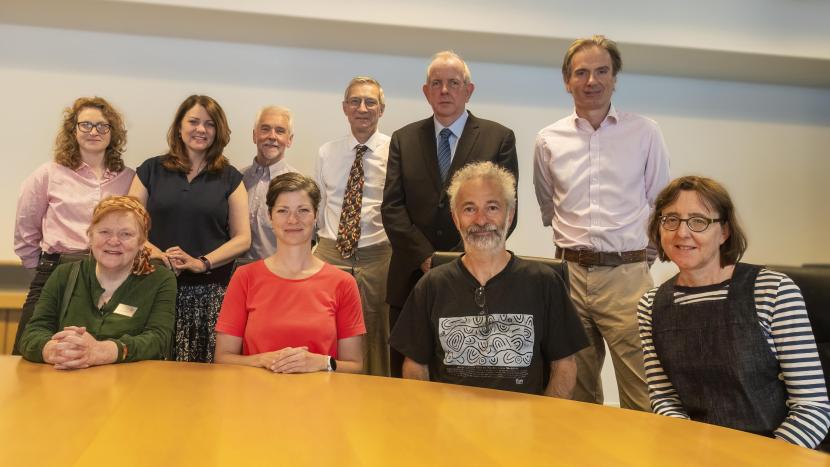 Board members standing around a table