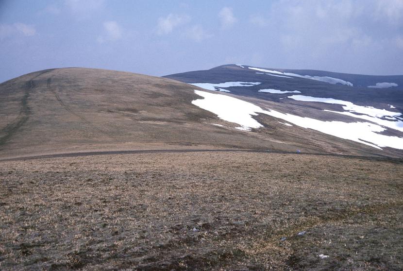 Ben Wyvis stretching into the distance, covered with patches of snow.