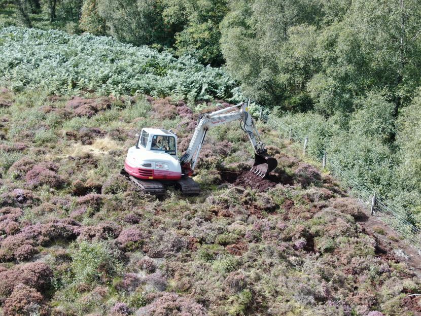 Machine operator starting the process of creating the bunds.