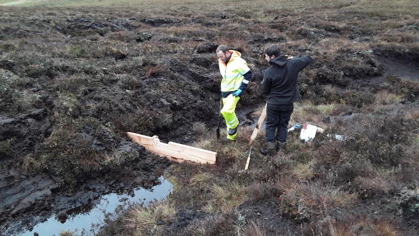 Cast study - two workers looking at timber sediment dams