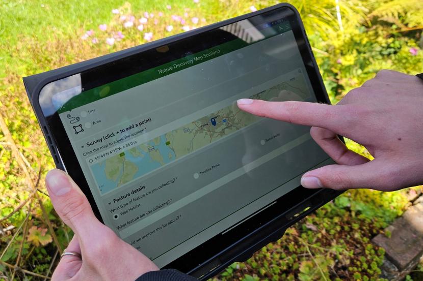 Hands holding a computer tablet showing the online toolkit