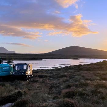 Restoration machinery on peatland with river in the background