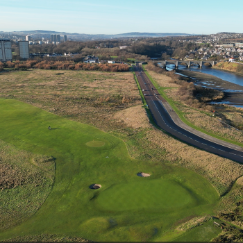 arial shot of the grassland along a river side