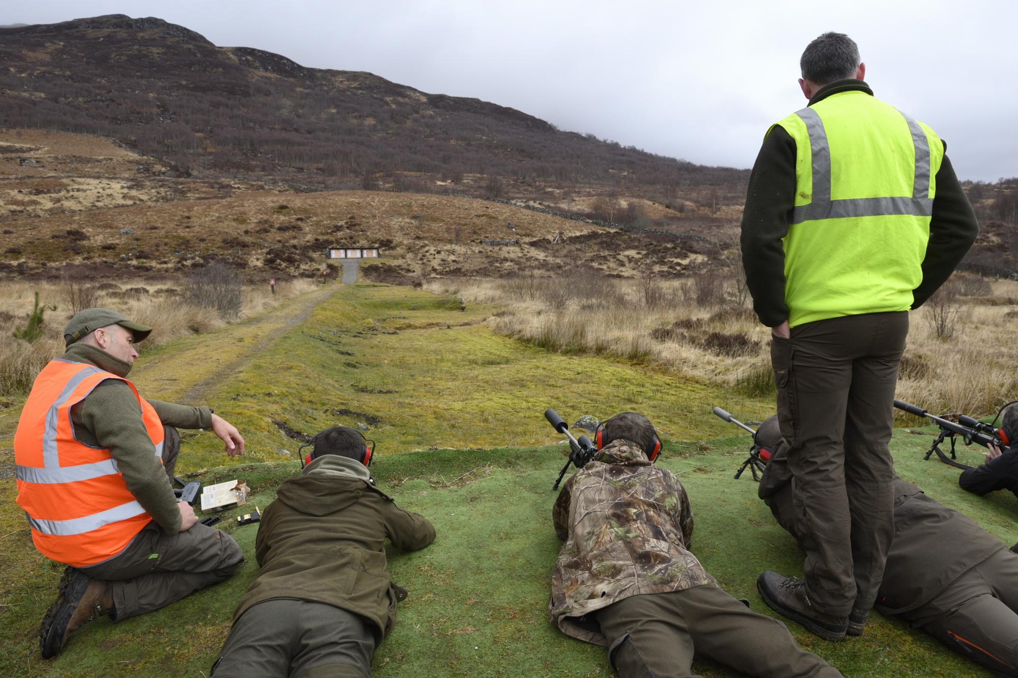 Students being shown how to use rifles for target practice, as part of the deer management training.