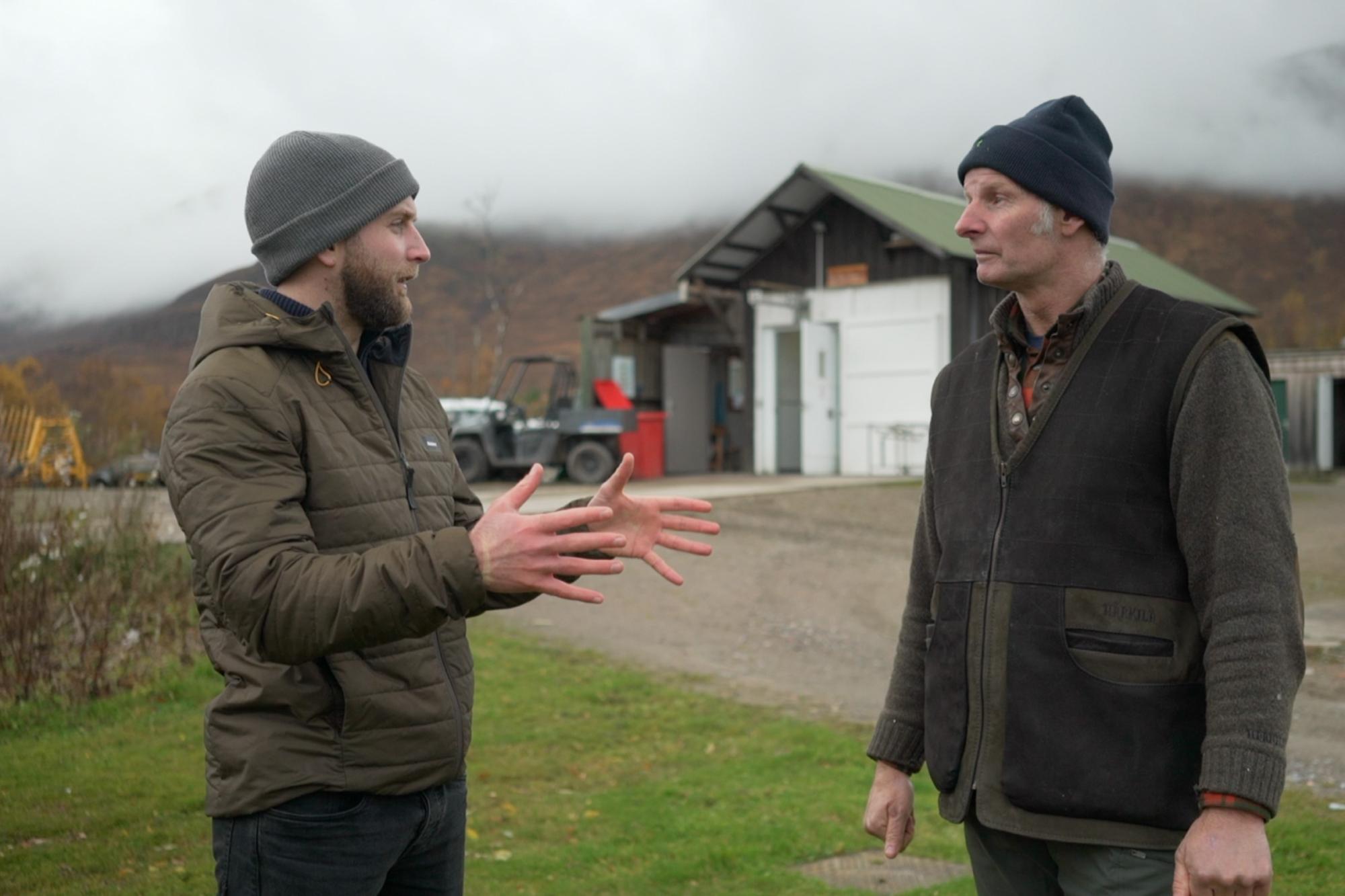 Two men talking outside the deerlarder at Creag Meagaidh 