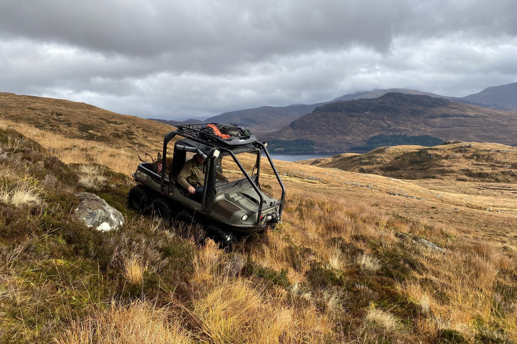 Deer stalking - an ATV driving down the hillside